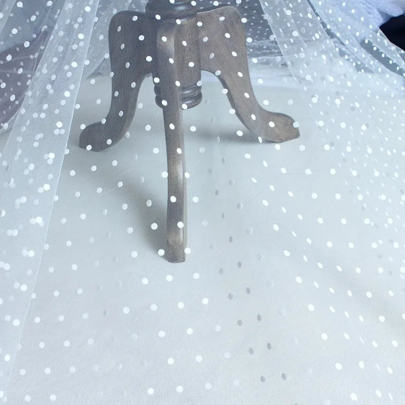 Sheer dot-pattern tulle draped over a dress form