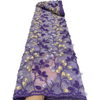Folded roll of purple floral embroidered chiffon lace showing repeating vine pattern