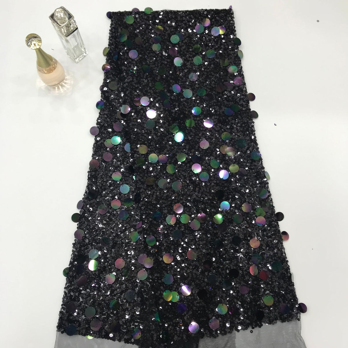 Black sheer embroidered mesh covered with iridescent round sequins