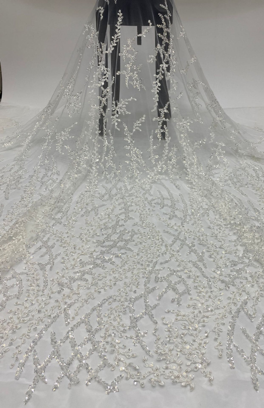 Full-length drape of sheer bridal fabric embellished with silver bead and sequin embroidery