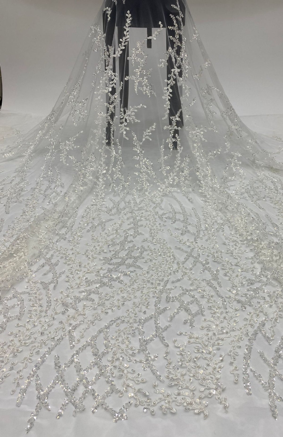 Full-length drape of sheer bridal fabric embellished with silver bead and sequin embroidery