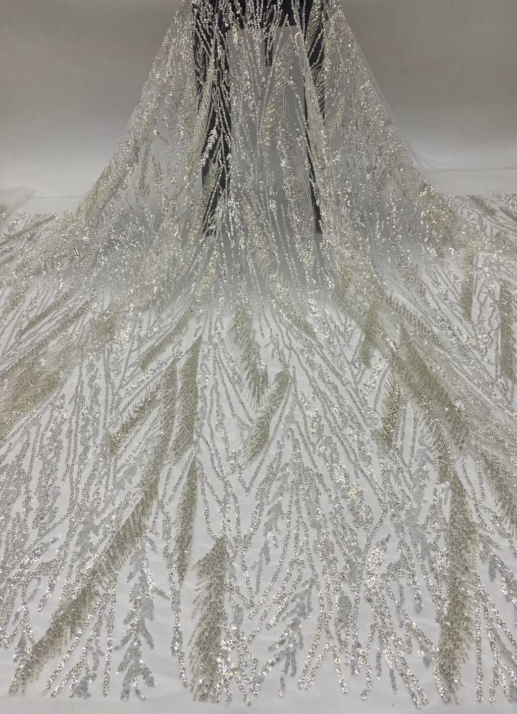 Draped light sheer fabric with densely worked silver botanical bead and sequin embroidery