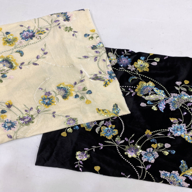 Color option fabrics showing ivory and black floral embroidered velvet samples