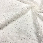 Close-up of pale sheer chiffon with fine silver crystal-look sequin embellishments
