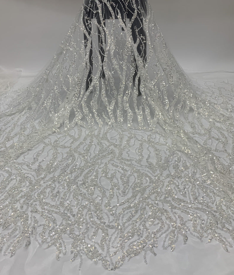 White sheer fabric with dense silver bead embroidery displayed as a long drape