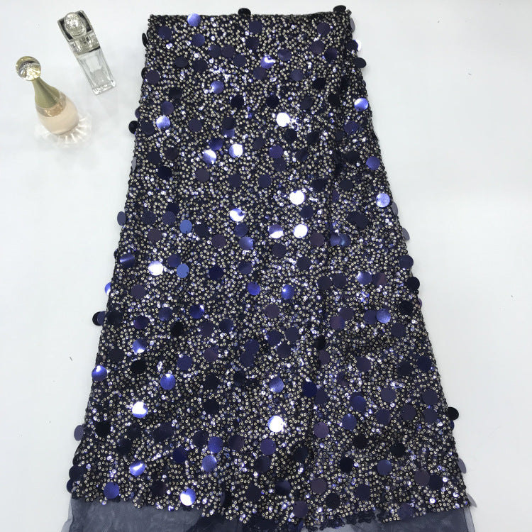 Blue-black sequin embroidered mesh fabric with scattered large reflective sequins