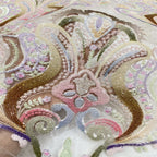 Close-up of colorful paisley and floral threadwork with sequined embellishment