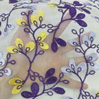 Sheer chiffon lace with purple and yellow floral vine embroidery on a pale base