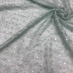 Silver crystal-look sequin chiffon fabric draped to show lightweight folds and scattered sparkle