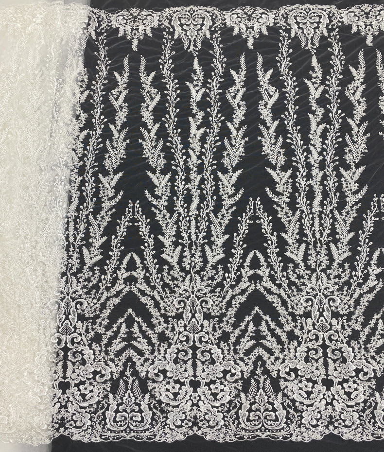 Black sheer fabric with high-contrast white beaded and sequined floral embroidery