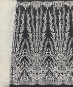 Black sheer fabric with high-contrast white beaded and sequined floral embroidery