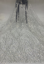 Draped silver crystal sequin fabric with delicate branching embroidered motifs on sheer mesh