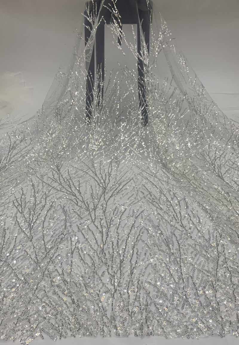 Draped silver crystal sequin fabric with delicate branching embroidered motifs on sheer mesh