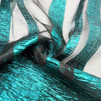 Draped turquoise organza jacquard showing reflective woven stripe texture