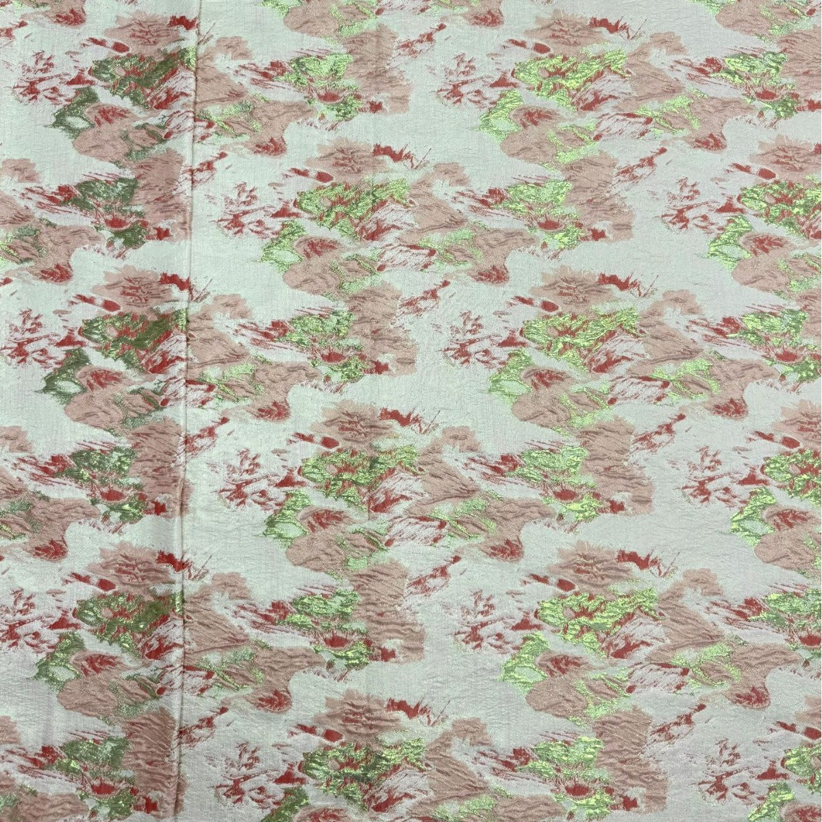 Pale floral decorative organza fabric showing pink roses and metallic woven texture