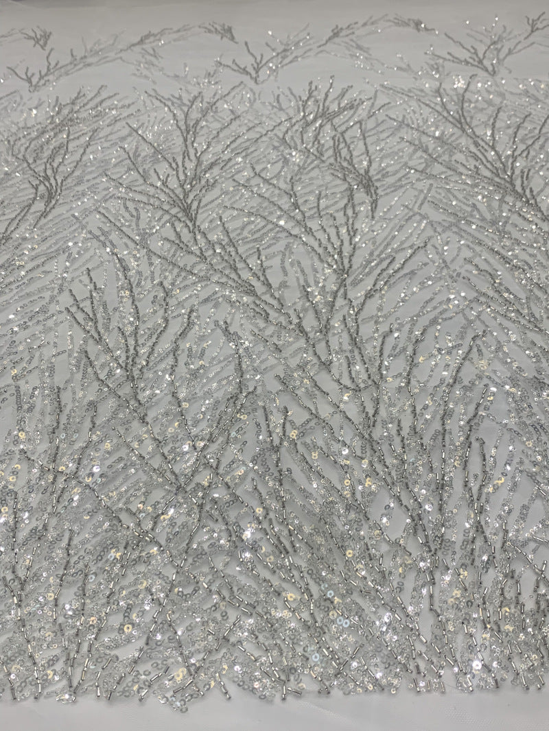 Close-up of branching silver bugle-bead and sequin pattern on sheer net