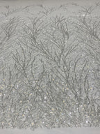 Close-up of branching silver bugle-bead and sequin pattern on sheer net