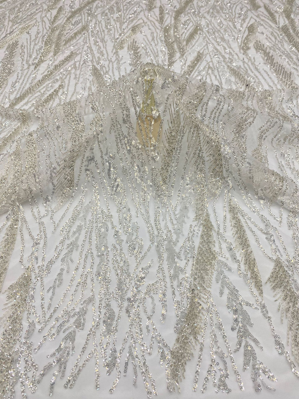 Close-up of densely embellished silver foliage-like bead and sequin texture