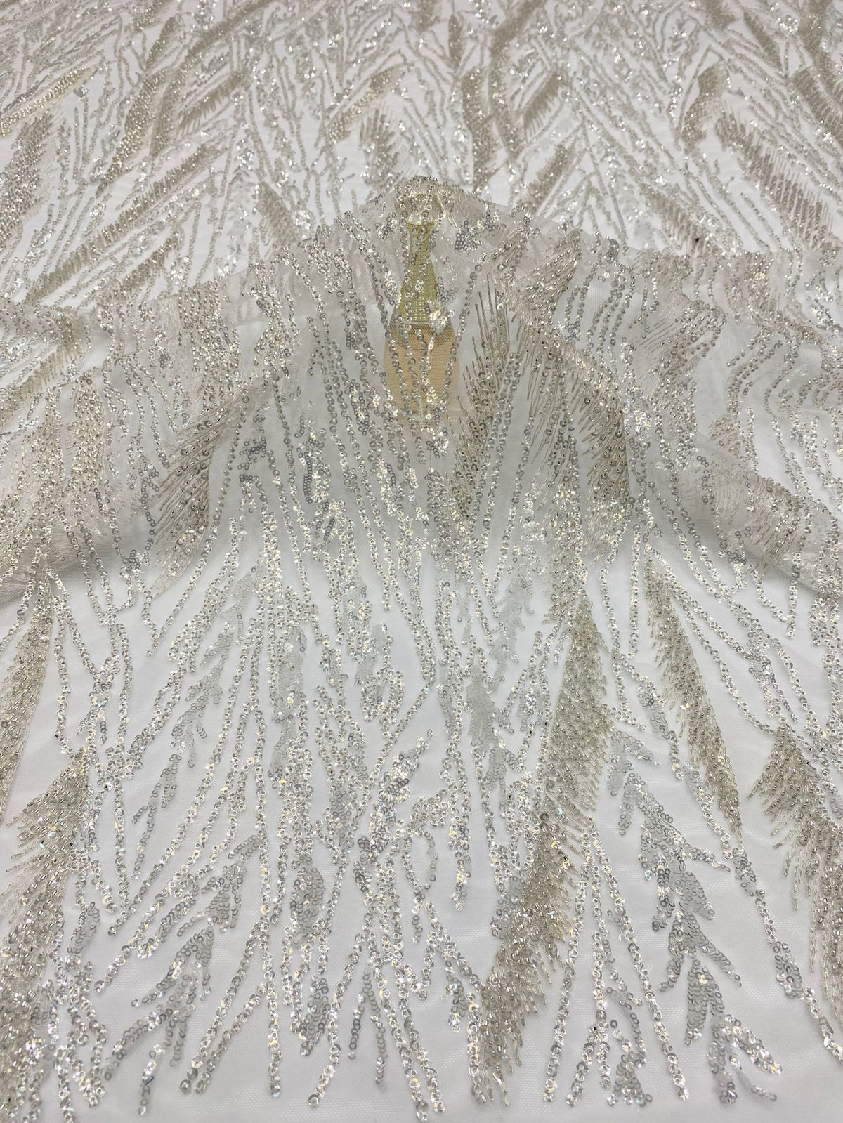 Close-up of densely embellished silver foliage-like bead and sequin texture
