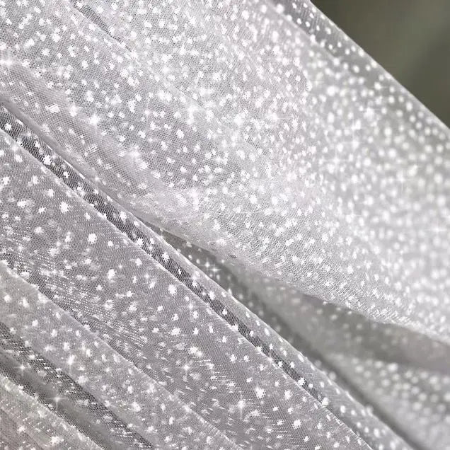 White dots with a shiny and soft net fabric suitable for wedding dresses and formal event decorations