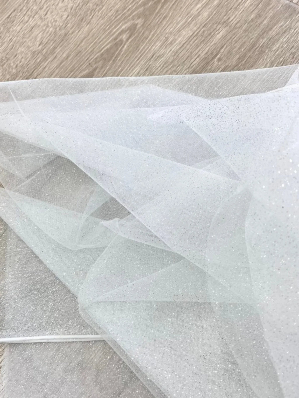 White fine sparkling silver powder with a hard and shiny transparent mesh background for wedding dress fabric decoration