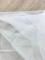 White fine sparkling silver powder with a hard and shiny transparent mesh background for wedding dress fabric decoration