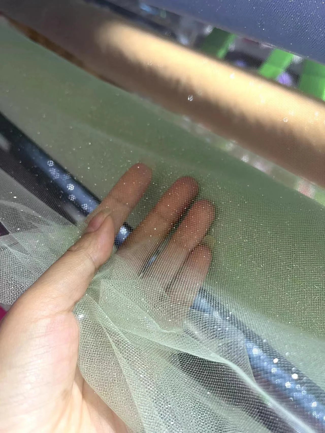 White fine sparkling silver powder with a hard and shiny transparent mesh background for wedding dress fabric decoration