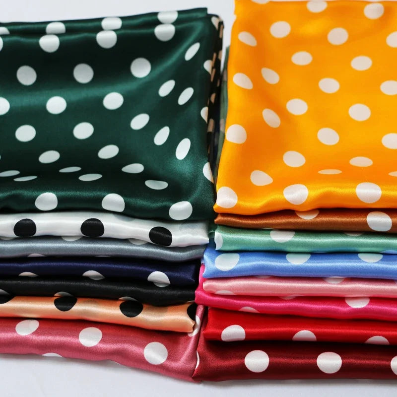 Stacked polka-dot satin fabric in green, orange, navy, pink and other colorways