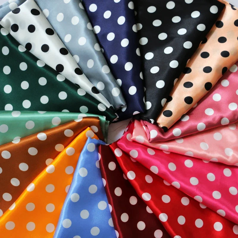 Multicolor polka-dot satin fabric arranged as fanned swatches with white dots