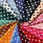 Multicolor polka-dot satin fabric arranged as fanned swatches with white dots