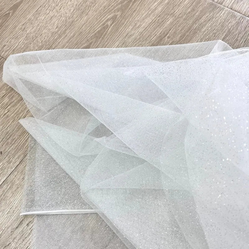 White fine sparkling silver powder with a hard and shiny transparent mesh background for wedding dress fabric decoration