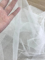 White fine sparkling silver powder with a hard and shiny transparent mesh background for wedding dress fabric decoration