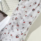 Tejido de malla elástica suave con hilo dorado y estampado de cerezas - Material transparente