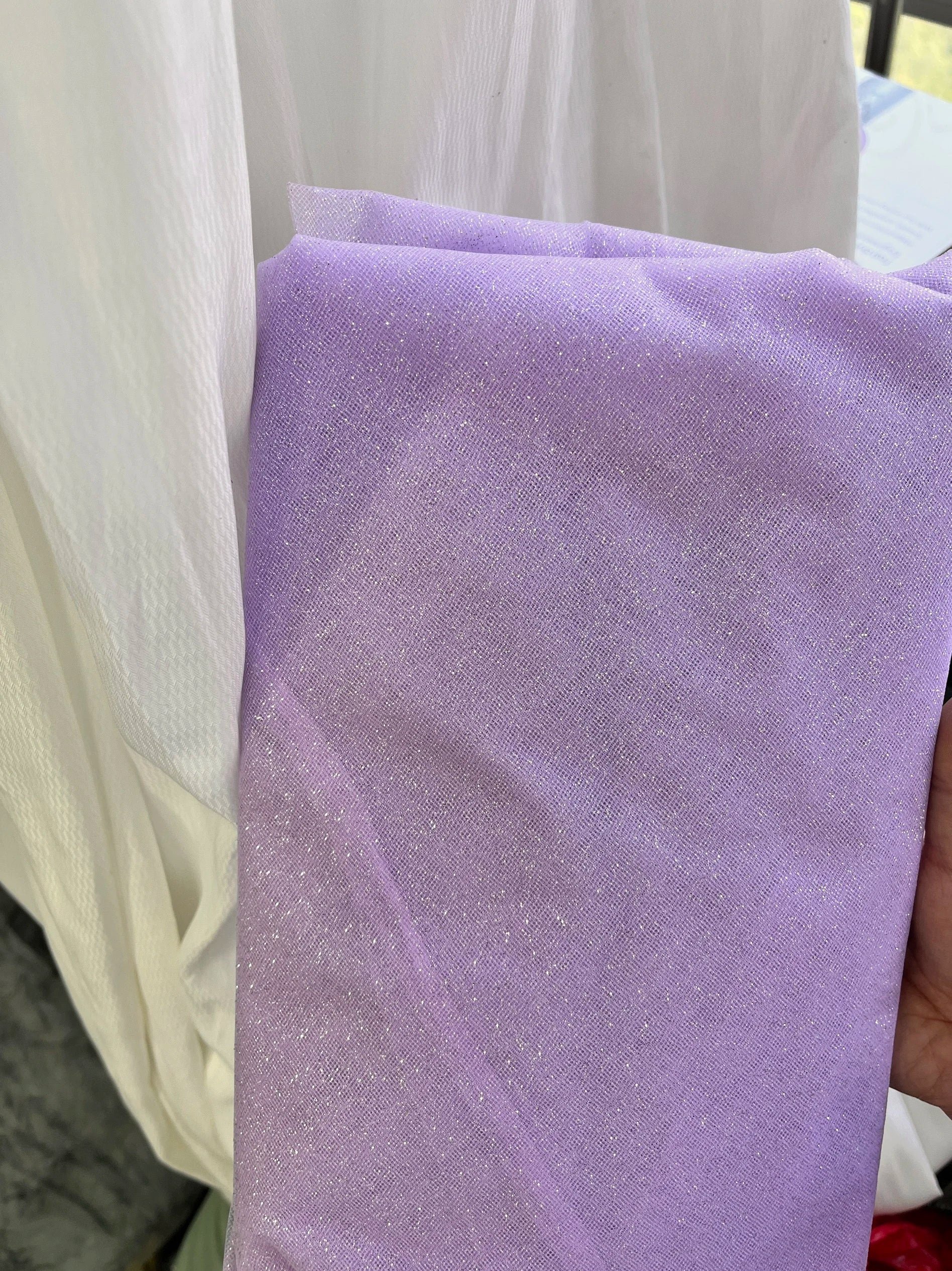 White fine sparkling silver powder with a hard and shiny transparent mesh background for wedding dress fabric decoration