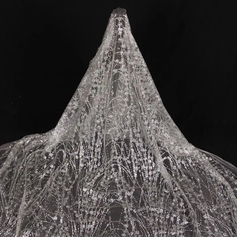 Gold-embossed sequin net fabric suitable for use in wedding dresses formal gowns and for decoration in wedding settings