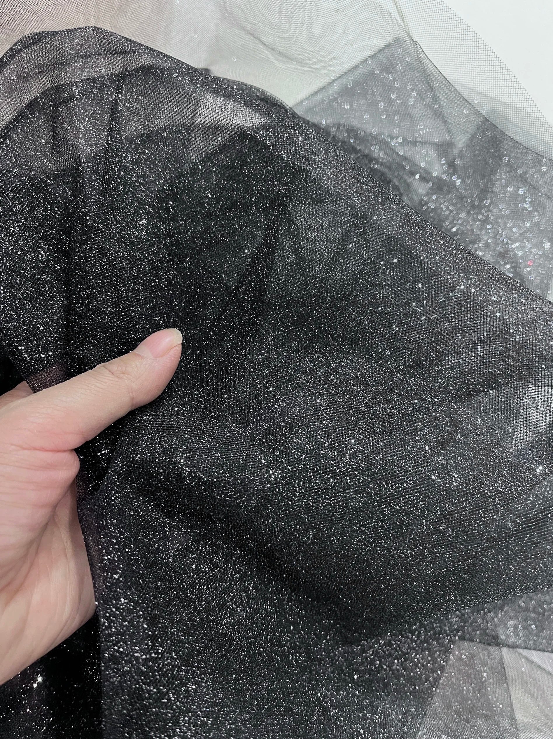 White fine sparkling silver powder with a hard and shiny transparent mesh background for wedding dress fabric decoration