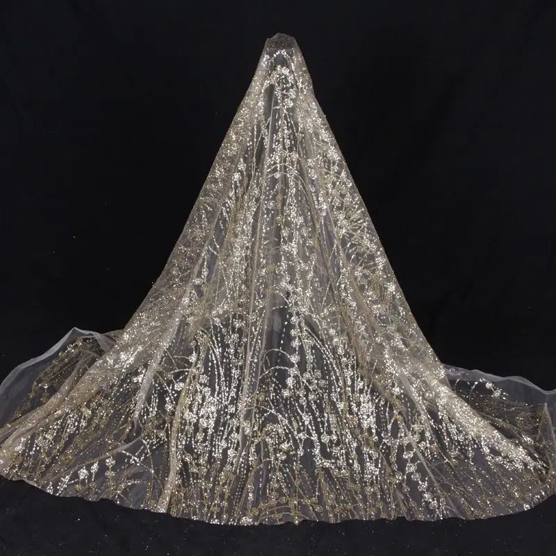 Gold-embossed sequin net fabric suitable for use in wedding dresses formal gowns and for decoration in wedding settings