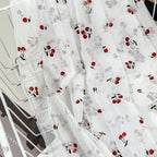 Tejido de malla elástica suave con hilo dorado y estampado de cerezas - Material transparente