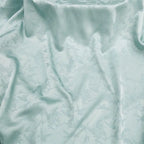 La nueva tela jacquard con estampado floral suave y brillante se puede usar para vestidos de novia, vestidos formales y ropa de bricolaje hecha a mano.