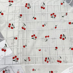 Tejido de malla elástica suave con hilo dorado y estampado de cerezas - Material transparente