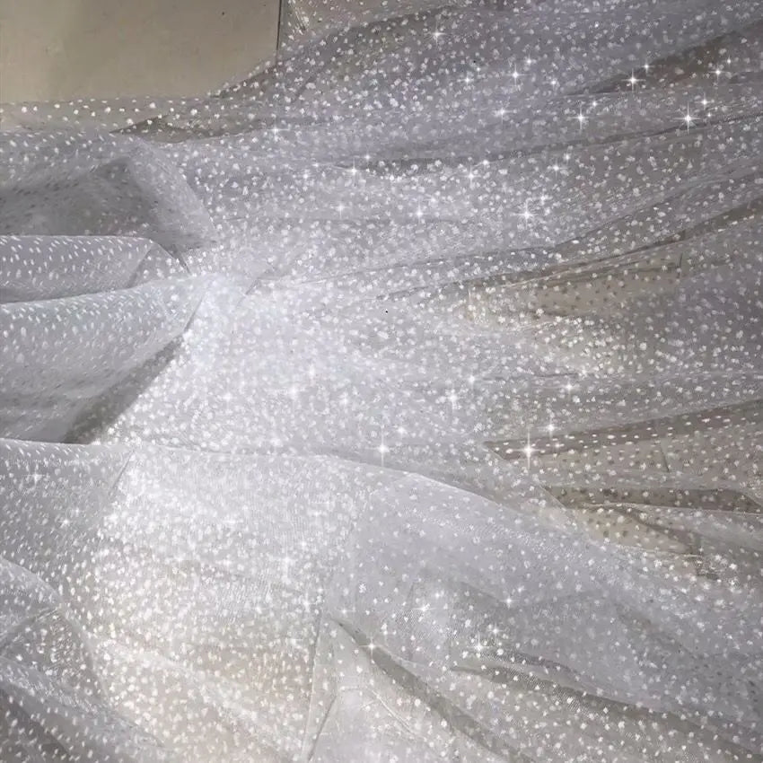 White dots with a shiny and soft net fabric suitable for wedding dresses and formal event decorations