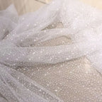 White dots with a shiny and soft net fabric suitable for wedding dresses and formal event decorations